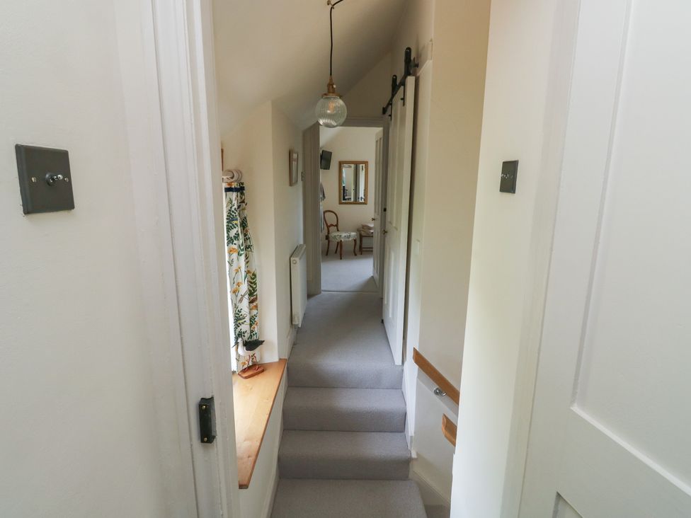 A hallway with a ceiling light and mirror at 13 School Road Newton Abbot