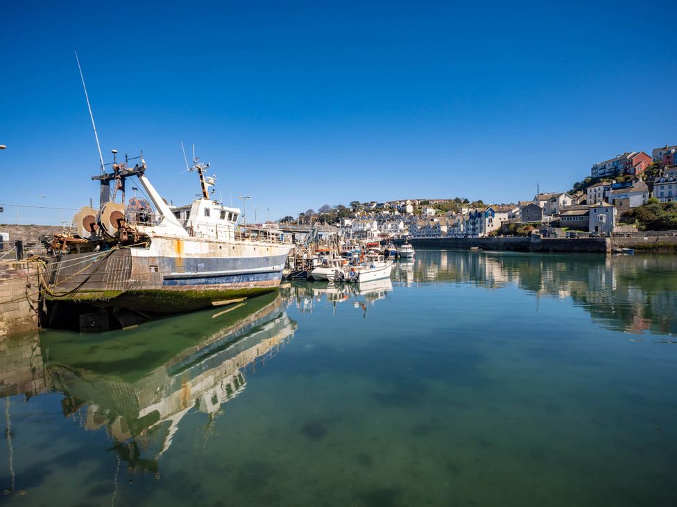 A harbor with fishing boats and houses at 13 School Road in Kingskerswell
