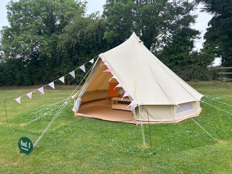 A bell tent with a tent number sign at Dovedale