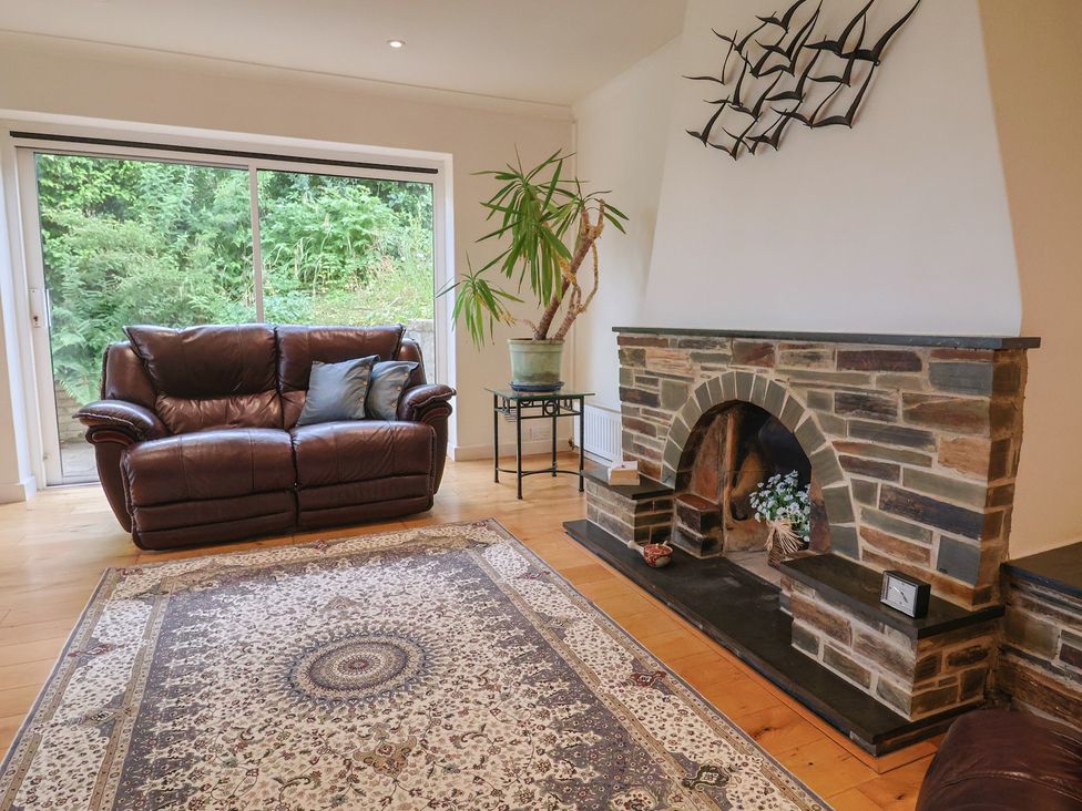 A living room with a sofa and fireplace at Hawksdown in Lyme Regis