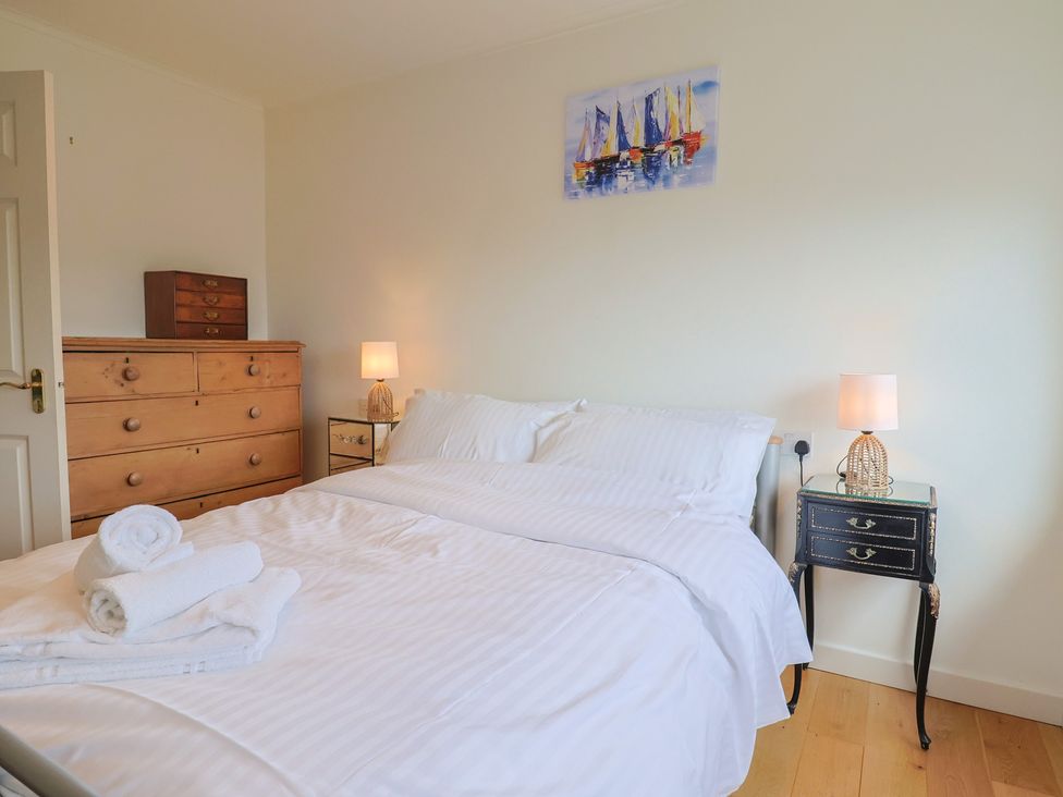 A bedroom with a bed and chest of drawers at Hawksdown in Lyme Regis