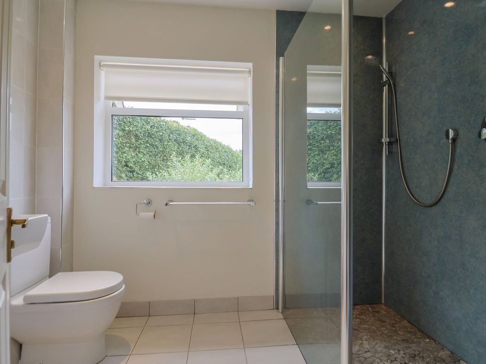A bathroom with a shower and toilet at Hawksdown Lyme Regis