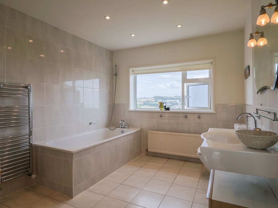 A bathroom with a bathtub and sink at Hawksdown in Lyme Regis