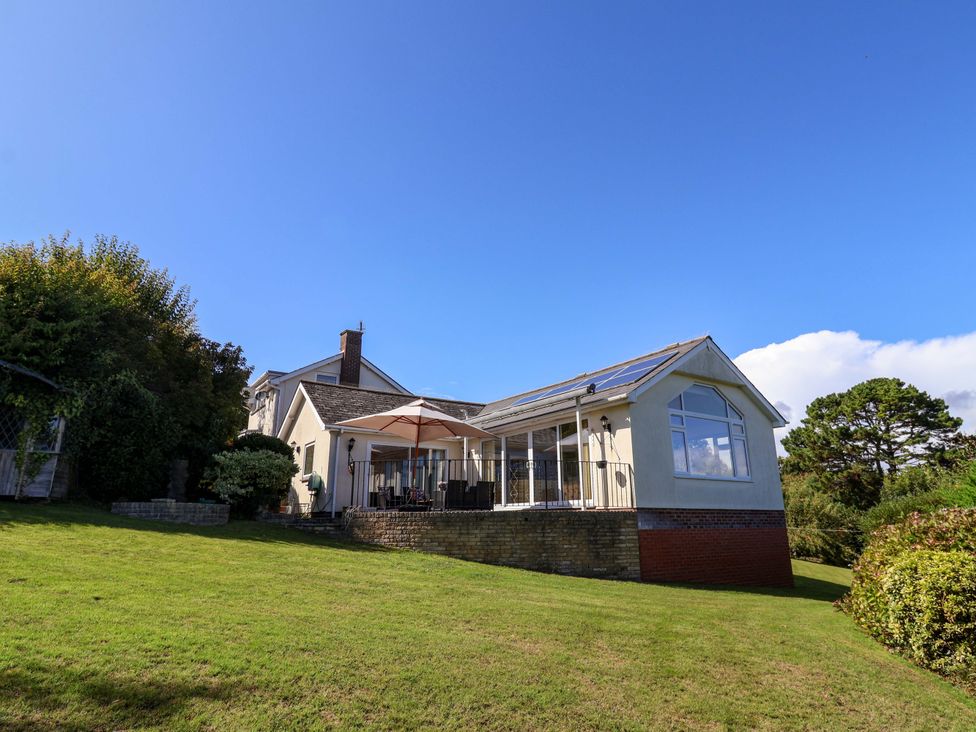 A house with a deck and canopy in the garden at Hawksdown Lyme Regis