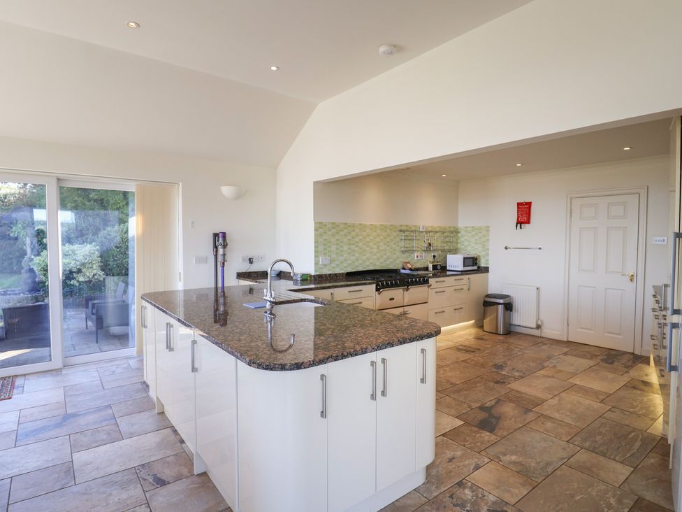A kitchen with a large island and appliances at Hawksdown in Lyme Regis