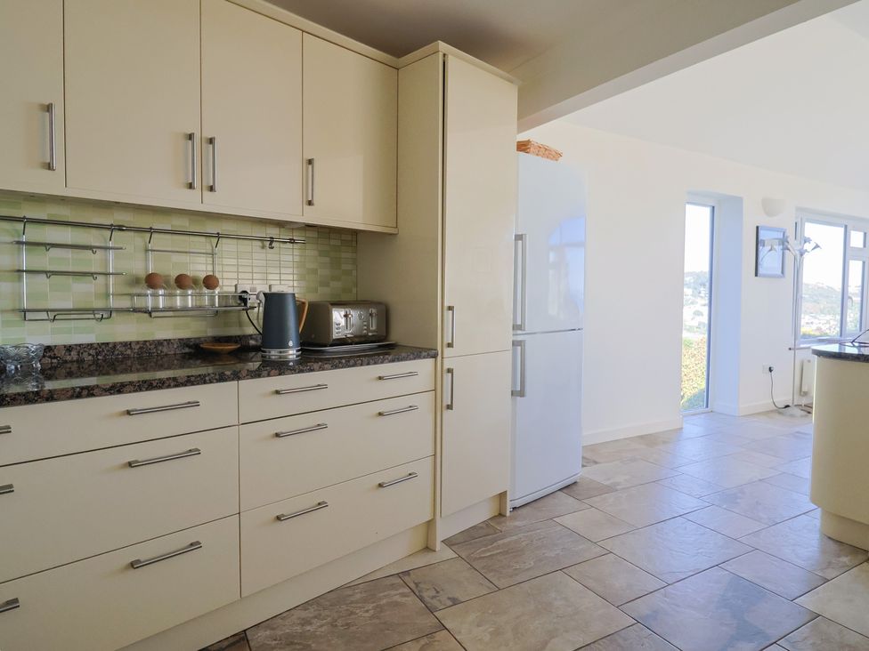 A kitchen with cabinets and appliances at Hawksdown in Lyme Regis