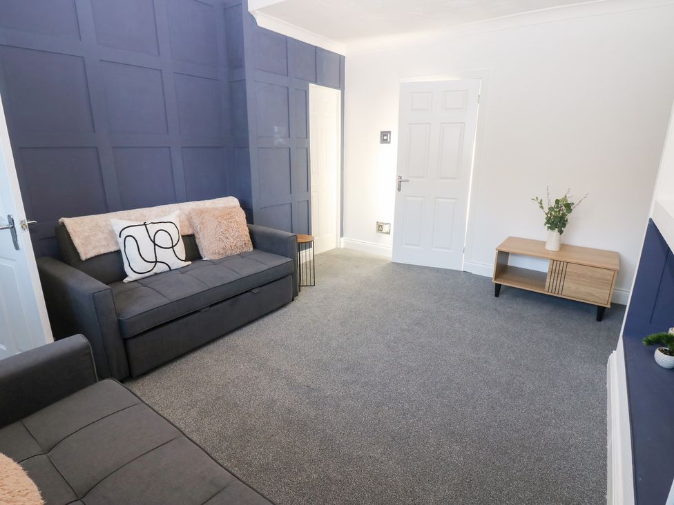 A living room with a sofa and side table at 16 Salvin Terrace Stockton-on-Tees