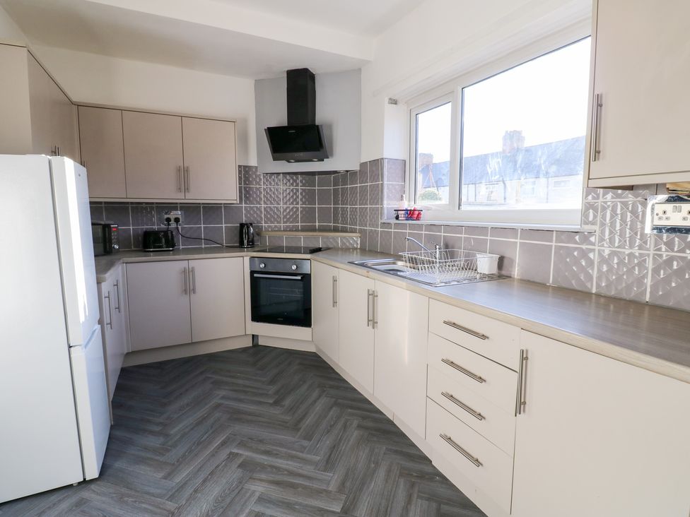 A kitchen with cabinets, a refrigerator, and an oven at 16 Salvin Terrace Stockton-on-Tees