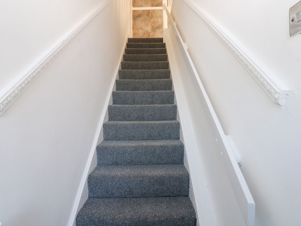 A staircase with carpet and handrail at 16 Salvin Terrace in Stockton-on-Tees