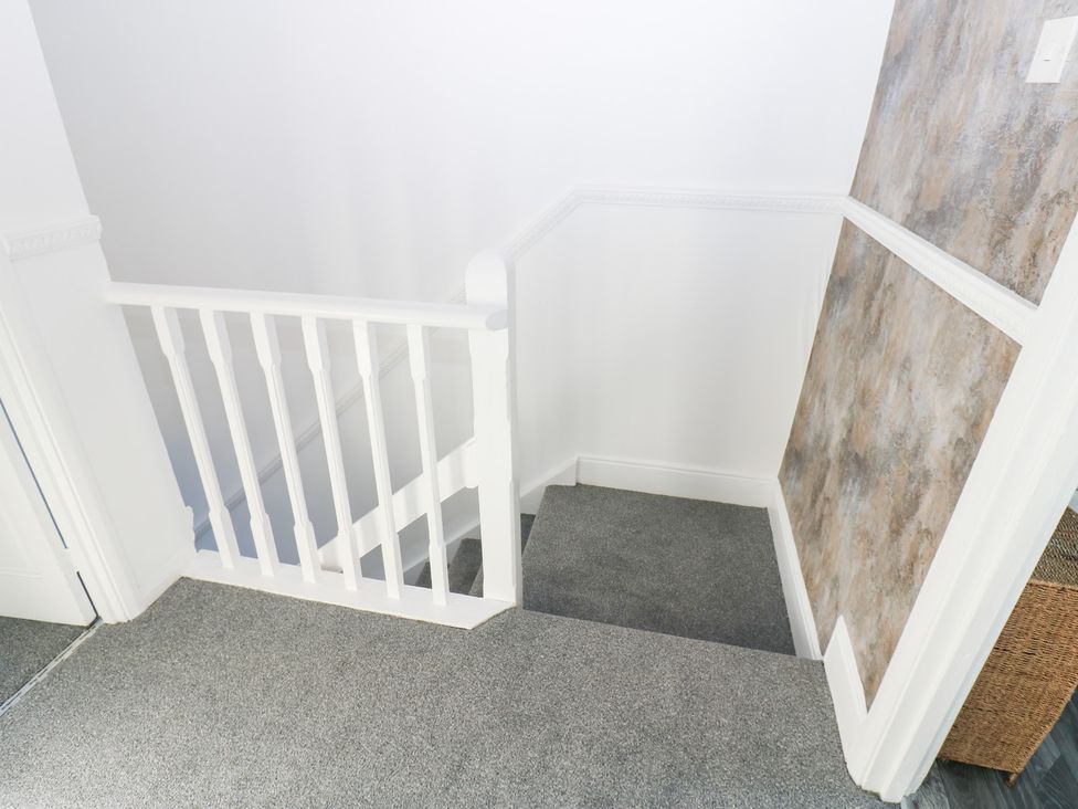 A staircase with a handrail and carpet at 16 Salvin Terrace, Stockton-on-Tees