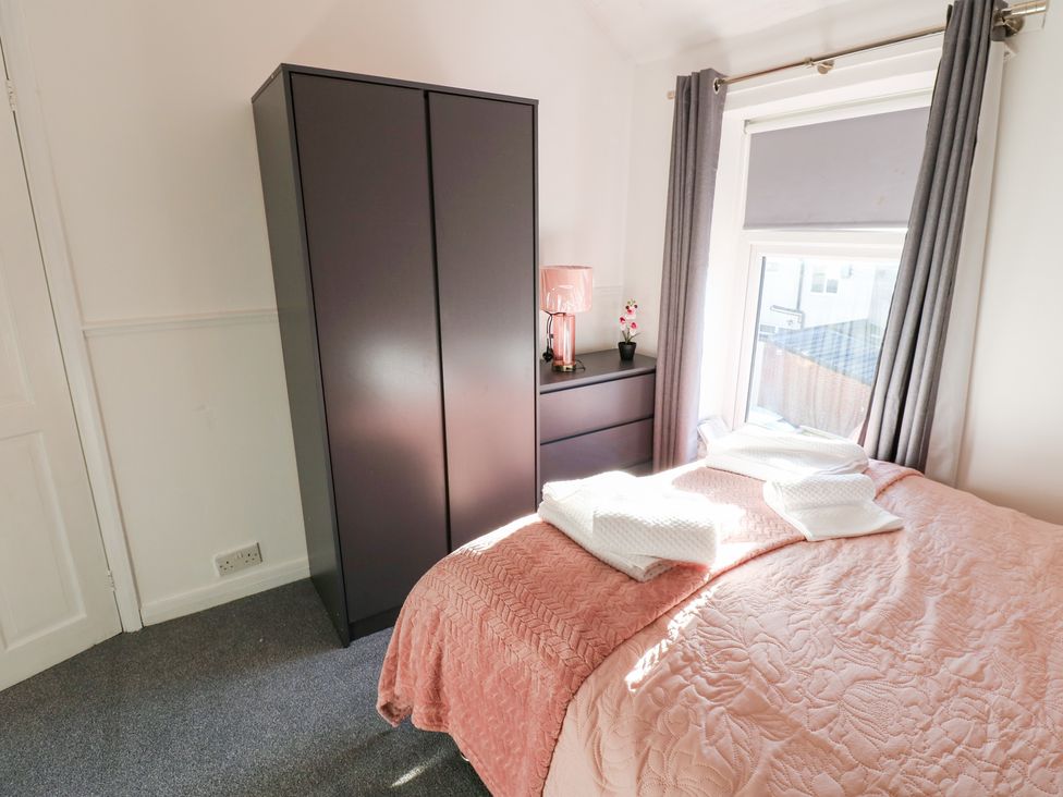 A bedroom with a bed and wardrobe at 16 Salvin Terrace Stockton-on-Tees