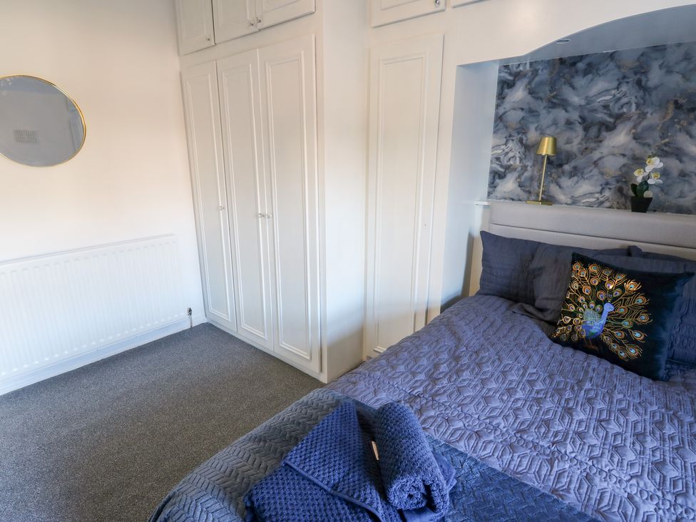 A bedroom with a bed and wardrobe at 16 Salvin Terrace in Stockton-on-Tees