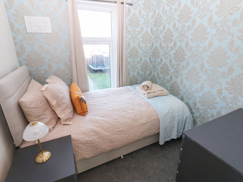 A bedroom with a bed and nightstand at 16 Salvin Terrace Stockton-on-Tees