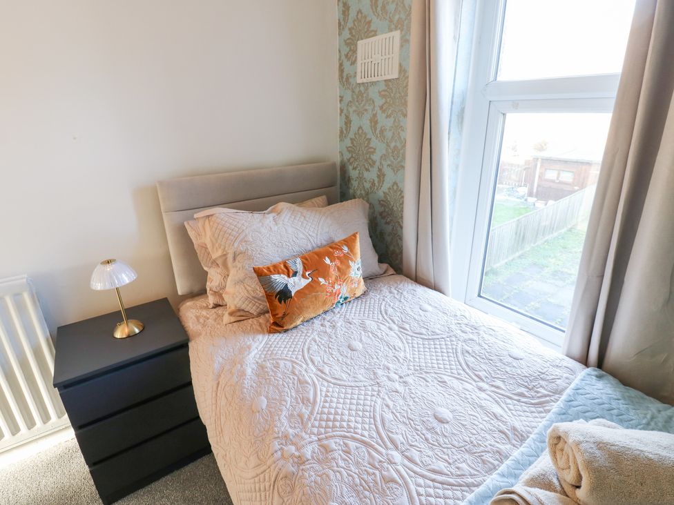 A bedroom with a bed near a window at 16 Salvin Terrace Stockton-on-Tees