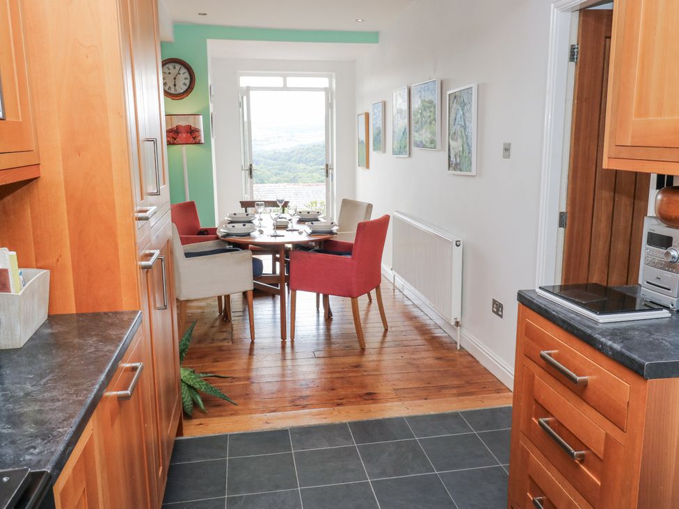 A kitchen with table and chairs at The Vista in Hebden Bridge
