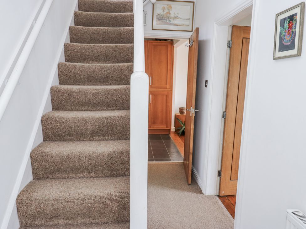 A staircase and an open door leading to the kitchen at The Vista in Hebden Bridge