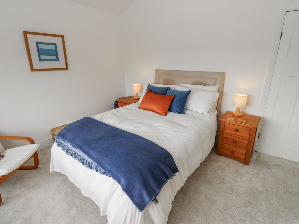 A bedroom with a bed and bedside tables at The Vista in Hebden Bridge