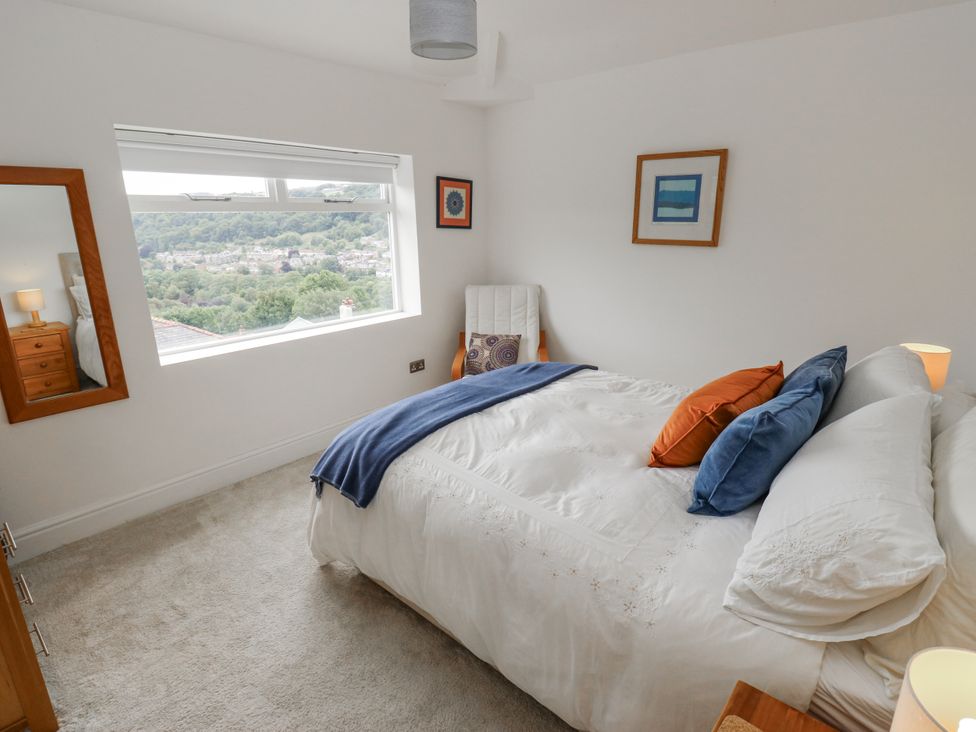 A bedroom with a bed and window at The Vista in Hebden Bridge