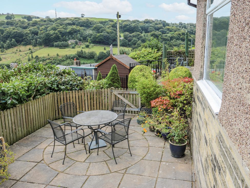 A garden with a table and chairs at The Vista in Hebden Bridge
