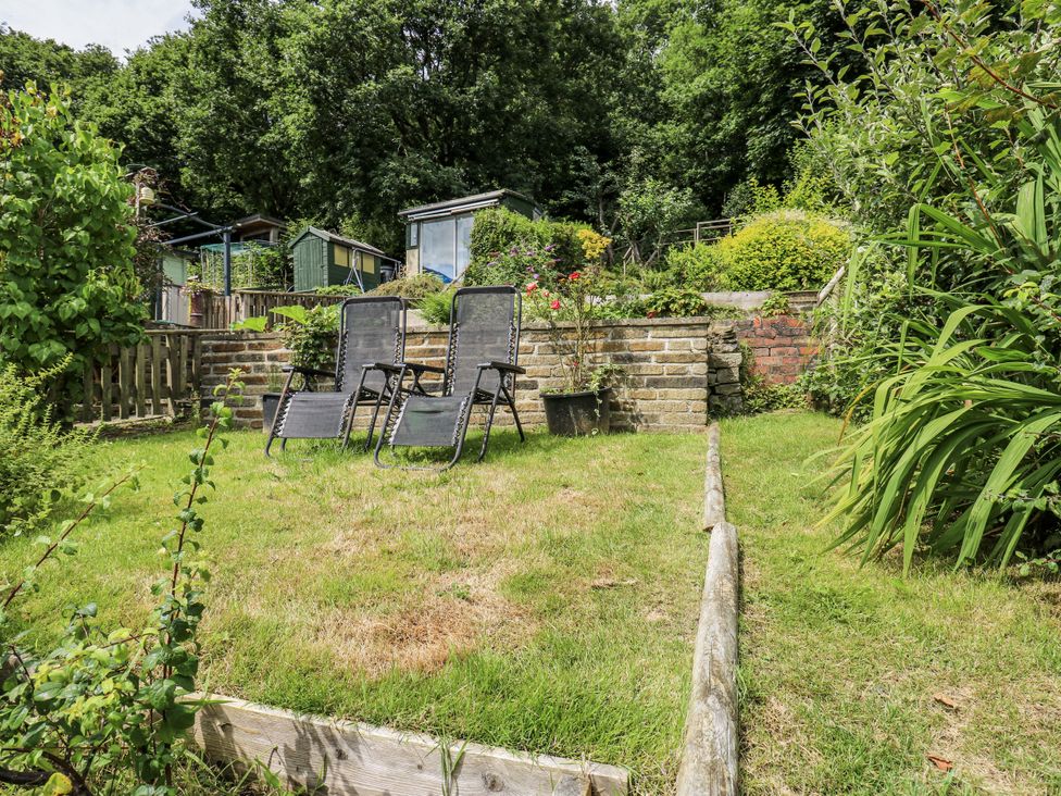 A garden with deck chairs and plants at The Vista in Hebden Bridge
