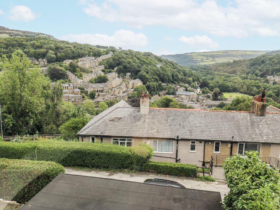 A view of houses and trees on a hillside at The Vista in Hebden Bridge