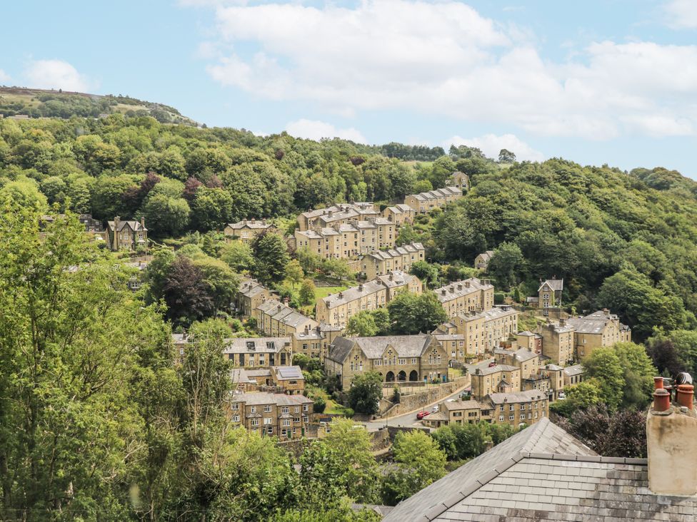 A view of houses and greenery in a hillside setting at The Vista in Hebden Bridge