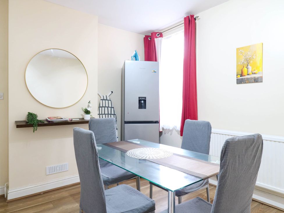 A dining room with a table and chairs at Dover Retreat