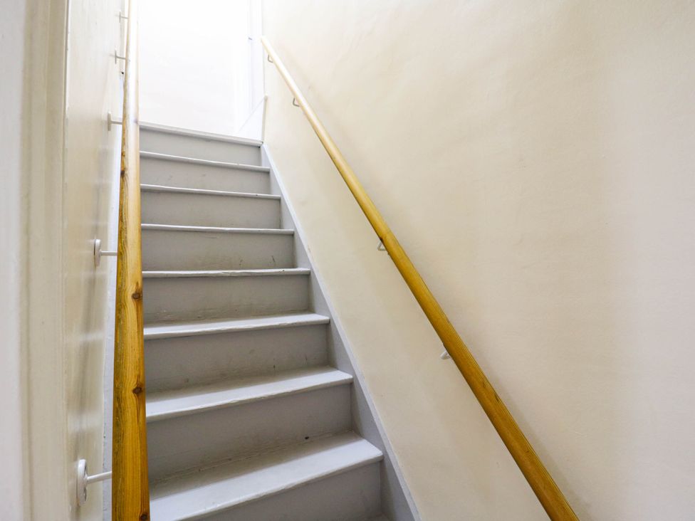 A staircase with a handrail at Dover Retreat