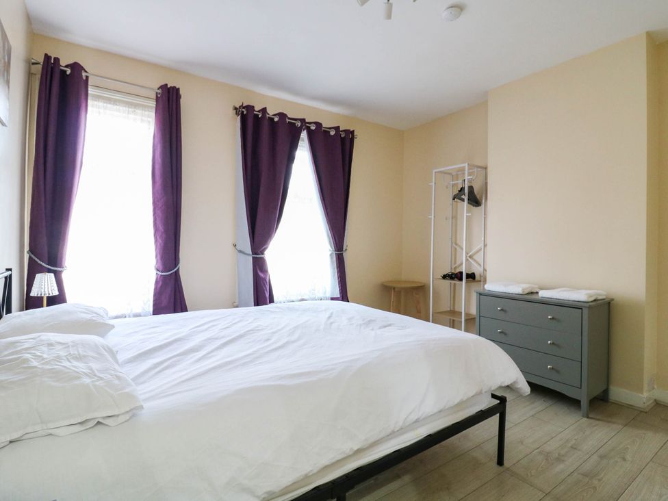 A bedroom with a bed and dresser at Dover Retreat