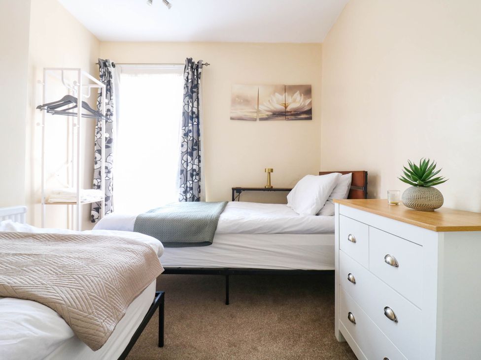 A bedroom with two beds and a dresser at Dover Retreat