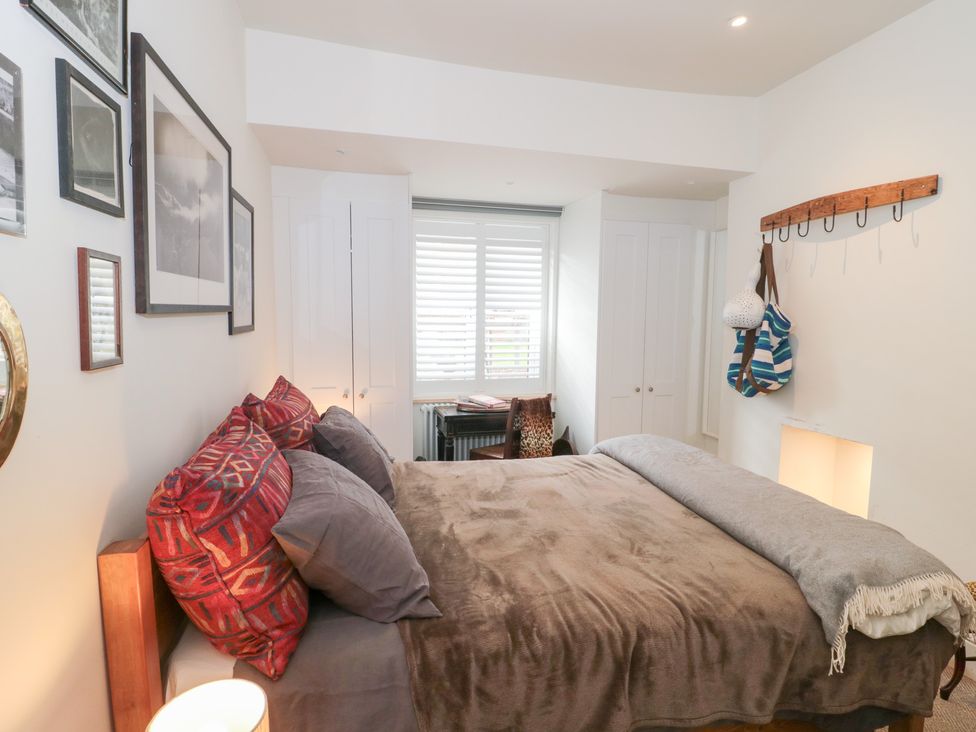 A bedroom with a bed and desk at Bohemian Beach Cottage in Bournemouth