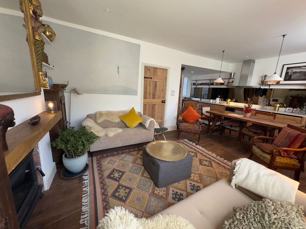 A living room with a sofa and coffee table at Bohemian Beach Cottage in Bournemouth