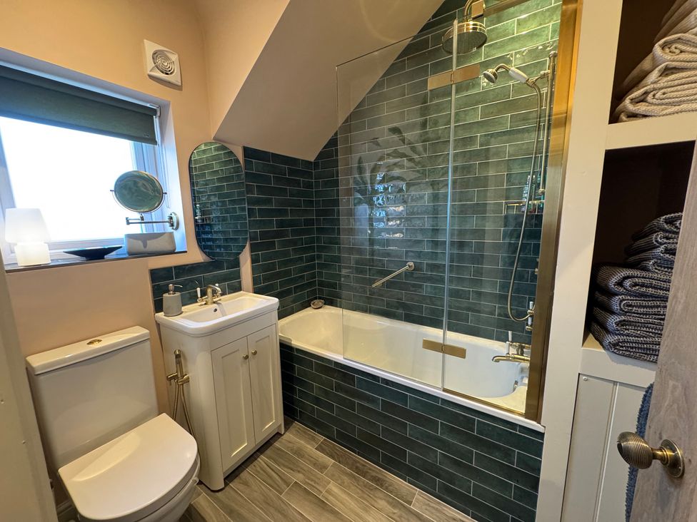 A bathroom with a sink and bathtub at Bohemian Beach Cottage in Bournemouth