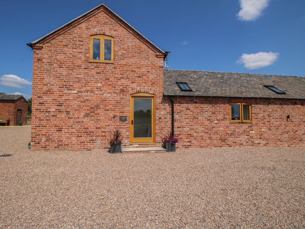 A house exterior with brick walls and a front door at Chestnut Barn, Shrewsbury