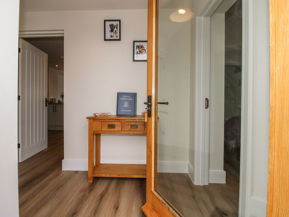 A hallway with a table and a book at Chestnut Barn Northwood near Wem