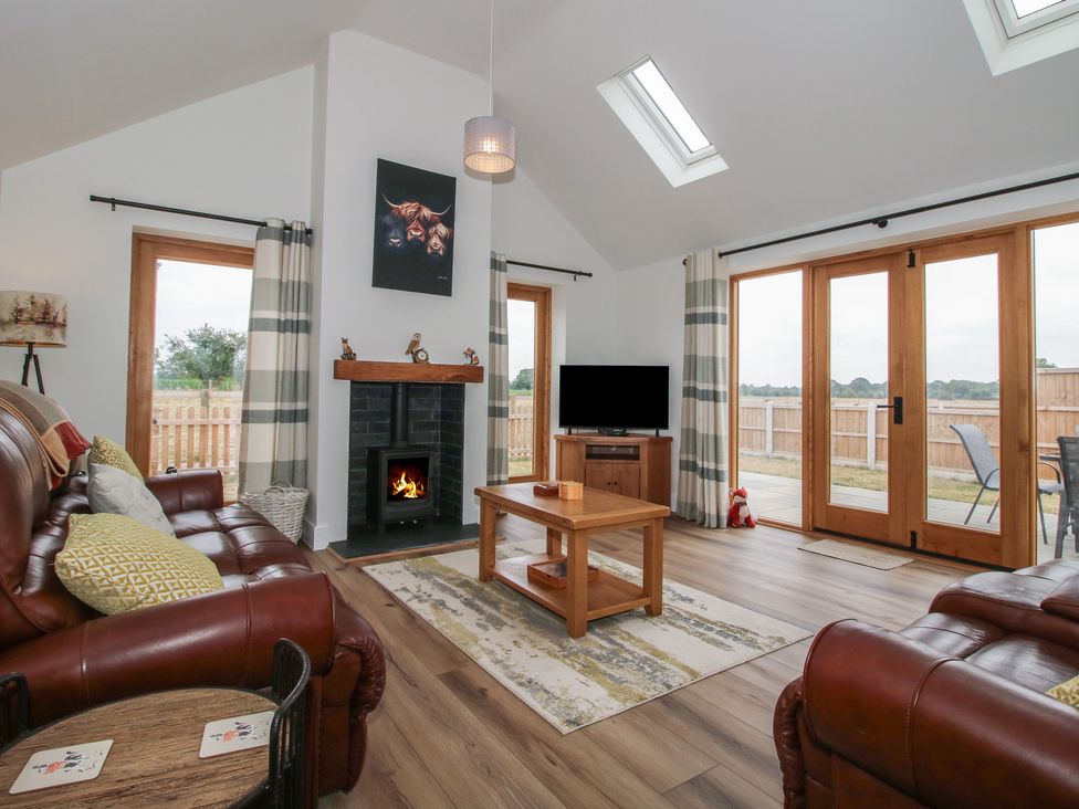 A living room with a sofa and television at Chestnut Barn in Northwood near Wem