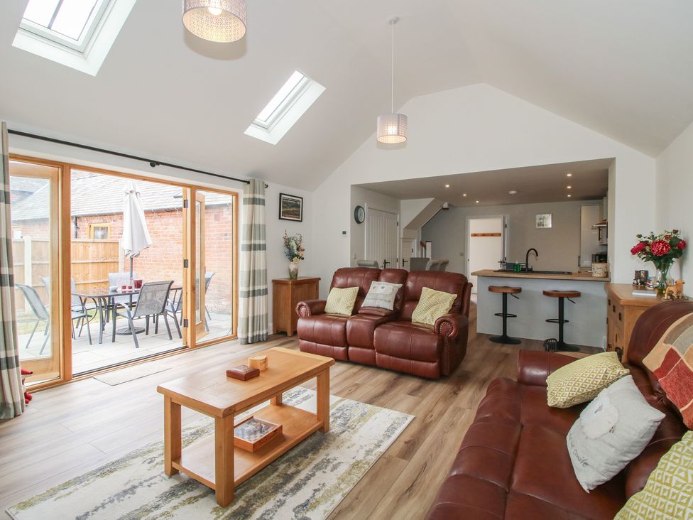 A living room with seating and a dining area at Chestnut Barn Northwood near Wem