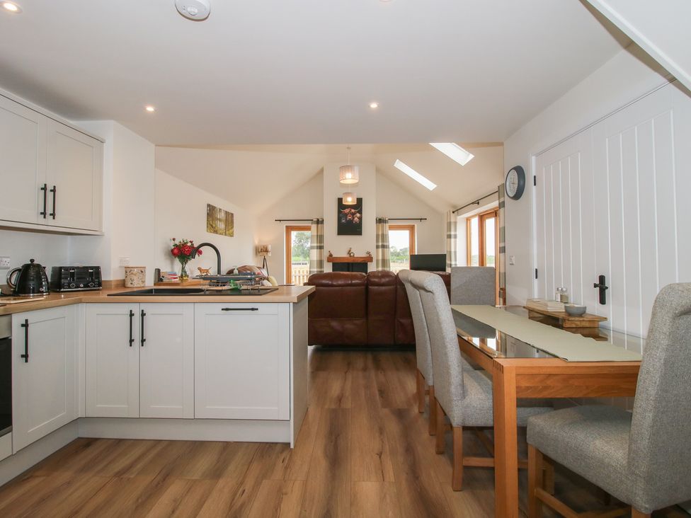 A kitchen with dining area and sofa at Chestnut Barn in Northwood near Wem