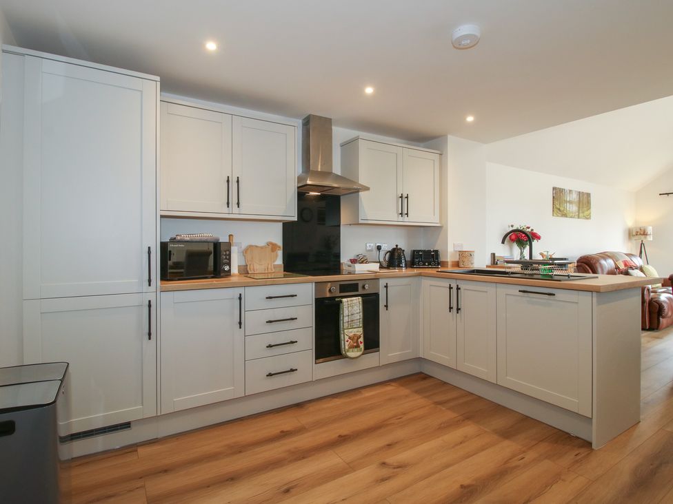 A kitchen with cabinets and appliances at Chestnut Barn in Northwood near Wem