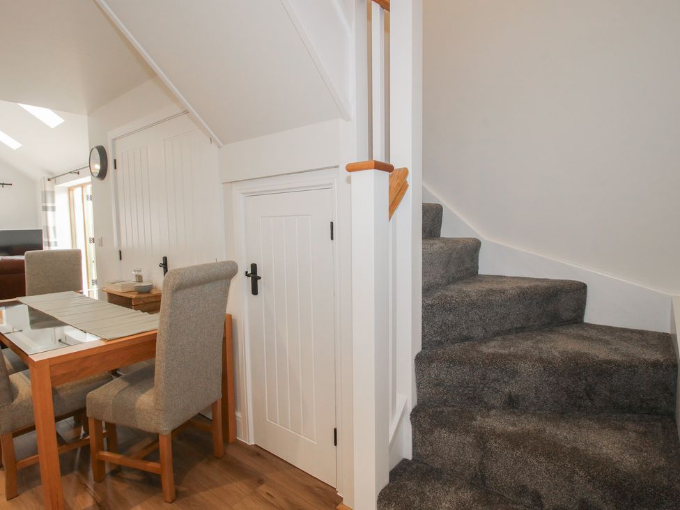 A dining area with a table and chairs at Chestnut Barn in Northwood near Wem