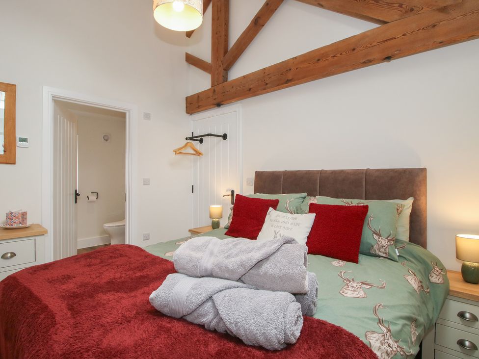 A bedroom with a bed and bedside table at Chestnut Barn Northwood near Wem