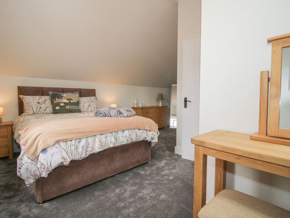 A bedroom with a bed and dresser at Chestnut Barn Northwood near Wem