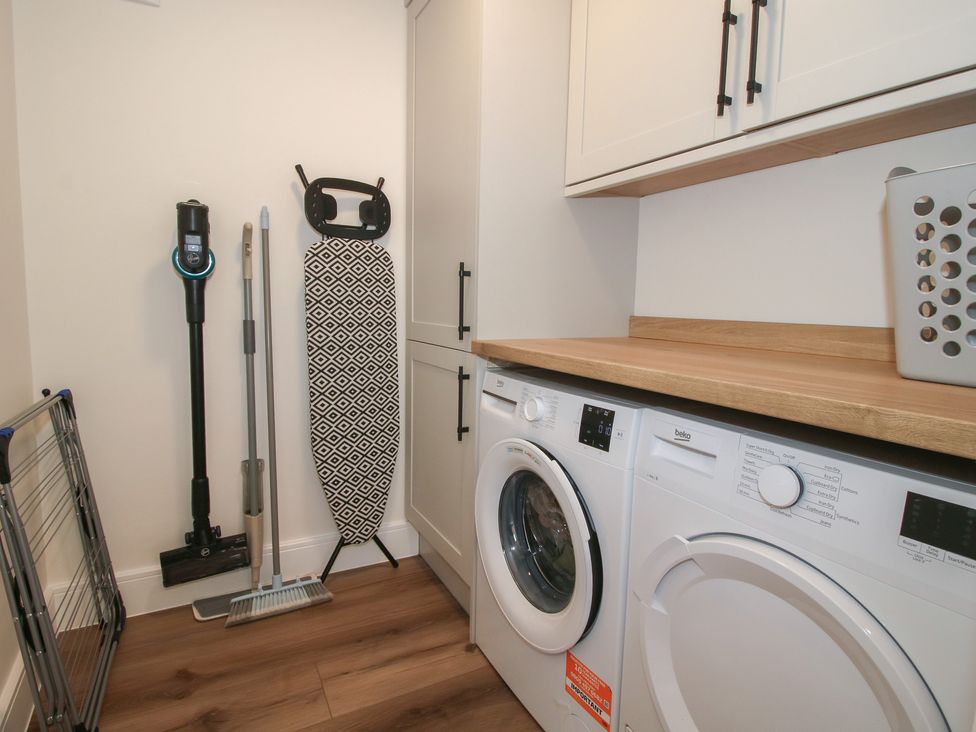A laundry room with a washing machine and drying machine at Chestnut Barn Northwood near Wem