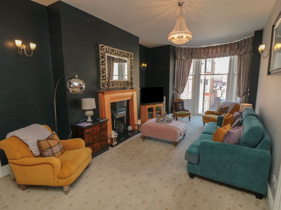 A living room with sofas and a fireplace at Stanton House - Abbey View, Flat 3