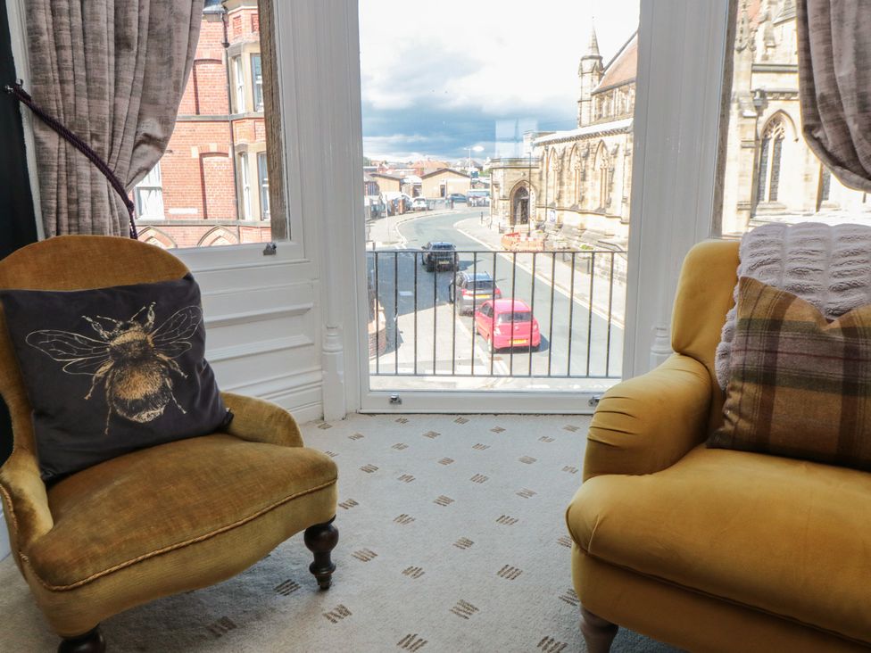 A living room with a view of the street and church at Stanton House - Abbey View, Flat 3 