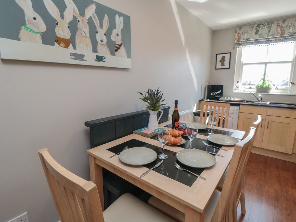 A dining room with a table set for breakfast at Stanton House - Abbey View, Flat 3