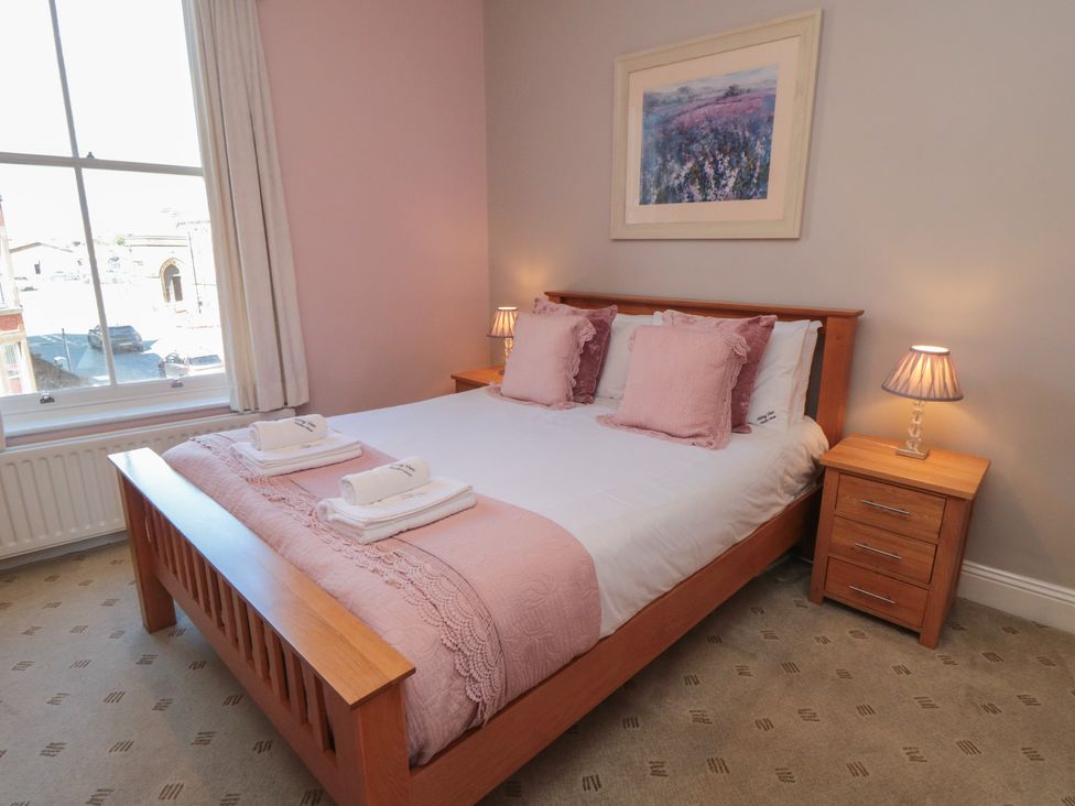 A bedroom with a bed and bedside tables at Stanton House - Abbey View, Flat 3