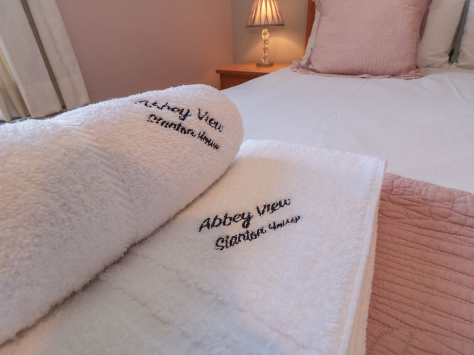 Towels on a bed at Stanton House - Abbey View, Flat 3