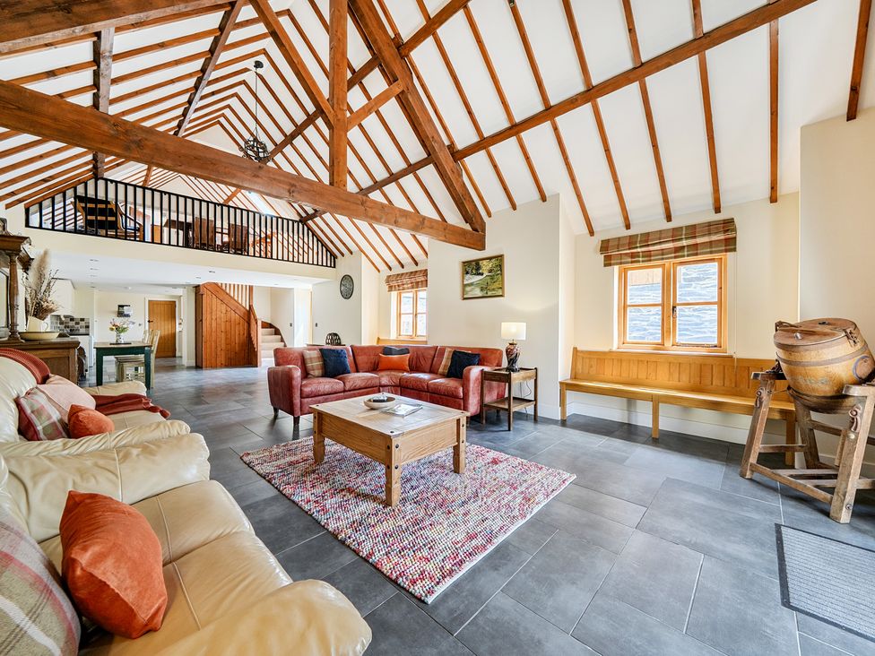 A living room with sofa and coffee table at The Dairy in Corwen