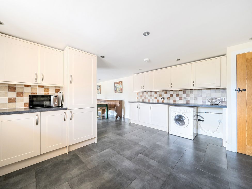 A kitchen with cabinets and appliances at The Dairy in Corwen